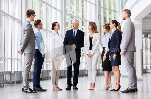 Image of business people talking at office building