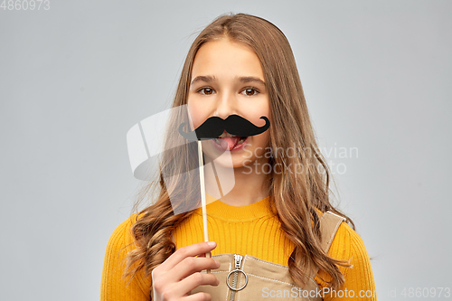 Image of teenage girl with black moustaches party accessory