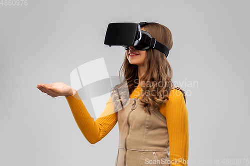 Image of teenage girl in vr glasses over grey background