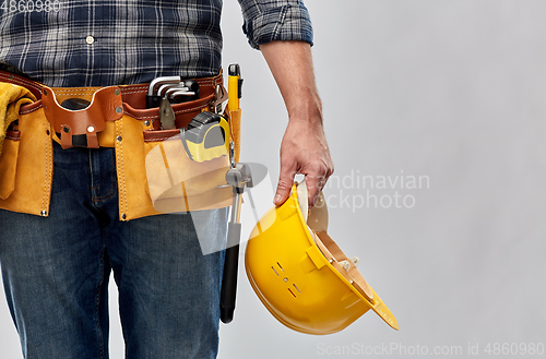 Image of worker or builder with helmet and working tools