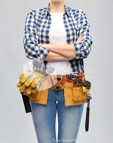 Image of woman or builder with working tools on belt
