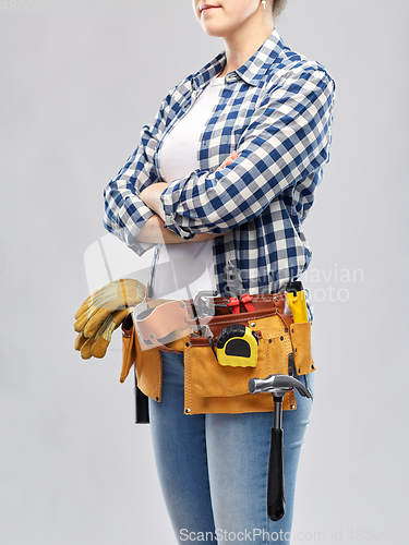 Image of woman or builder with working tools on belt