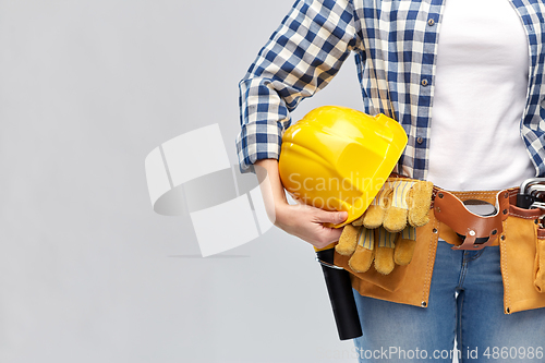 Image of woman or builder with helmet and working tools