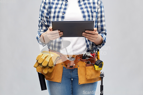 Image of woman or builder with tablet pc and working tools