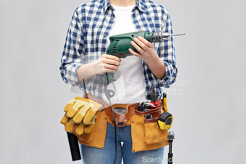 Image of woman or builder with drill and work tools