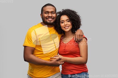 Image of happy african american couple hugging