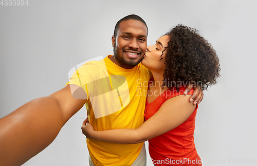 Image of happy smiling african american couple takes selfie