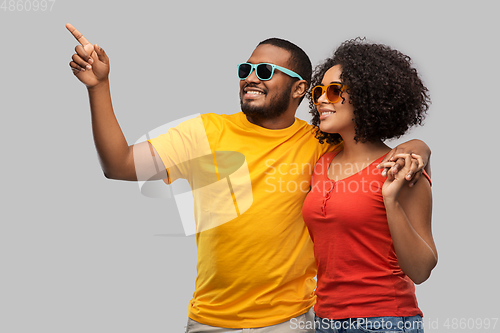 Image of happy african american couple in sunglasses