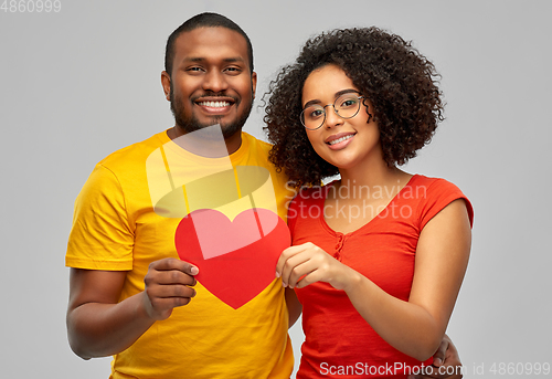 Image of happy african american couple holding red heart