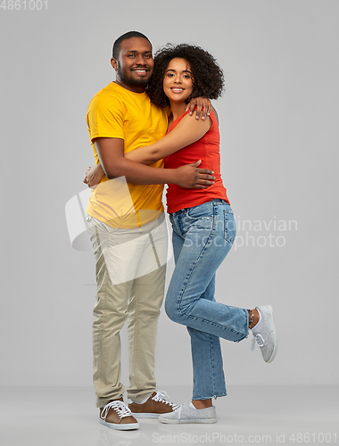 Image of happy african american couple hugging