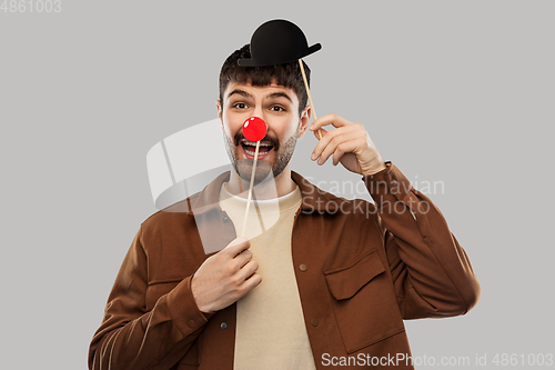 Image of smiling man with bowler hat and red clown nose