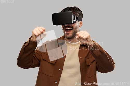 Image of happy smiling young man in vr glasses