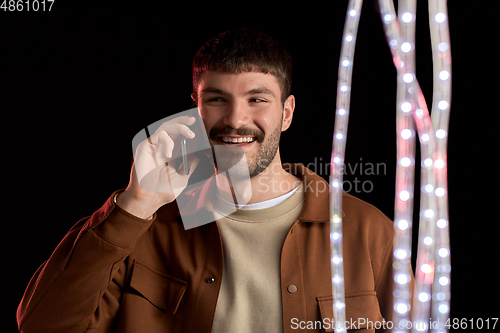 Image of smiling young man in yellow sweatshirt