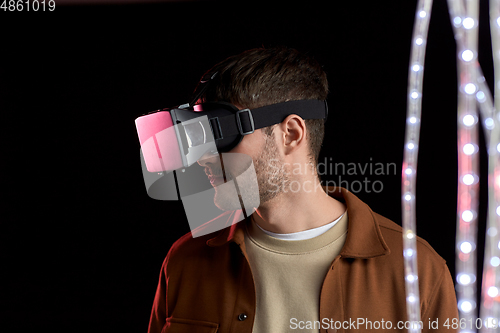 Image of man in vr glasses over black background