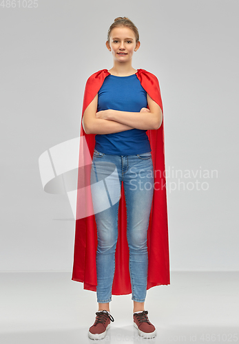 Image of smiling teenage girl in red superhero cape