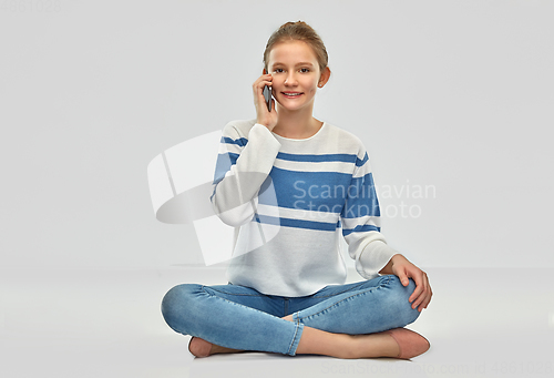 Image of happy smiling teenage girl calling on smartphone