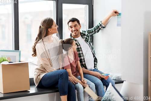 Image of happy family with color palette moving to new home