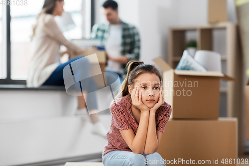 Image of sad girl moving to new home with her family