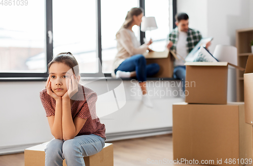 Image of sad girl moving to new home with her family