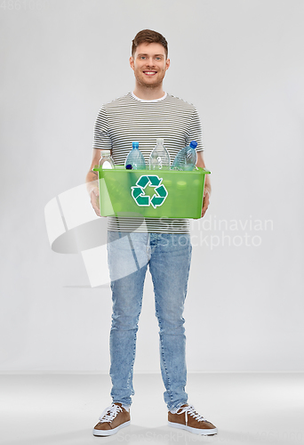 Image of smiling young man sorting plastic waste