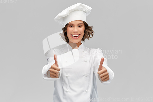 Image of smiling female chef in toque showing thumbs up