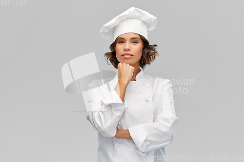 Image of female chef in toque thinking