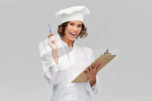 Image of smiling female chef in toque with clipboard