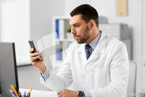 Image of male doctor with smartphone at hospital