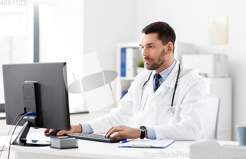 Image of male doctor with computer working at hospital