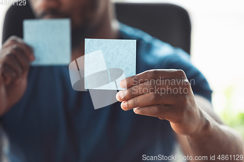 Image of Close up of african-american male hands, working in office