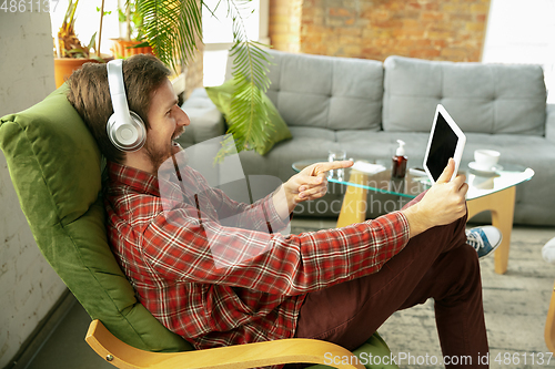 Image of Caucasian man staying at home during quarantine because of coronavirus spreading