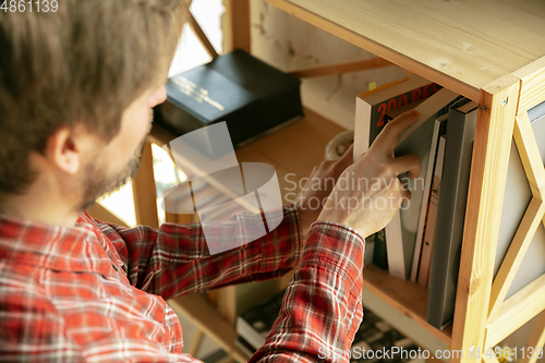 Image of Caucasian man staying at home during quarantine because of coronavirus spreading