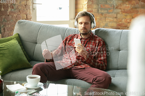 Image of Caucasian man staying at home during quarantine because of coronavirus spreading