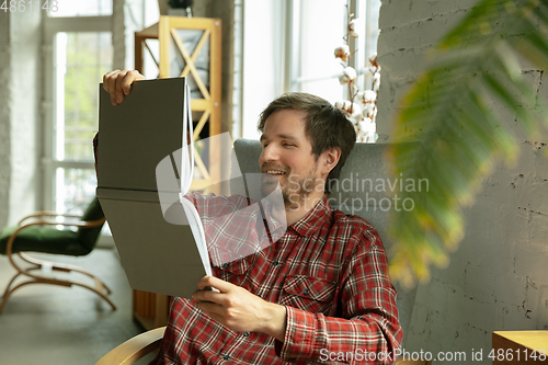 Image of Caucasian man staying at home during quarantine because of coronavirus spreading