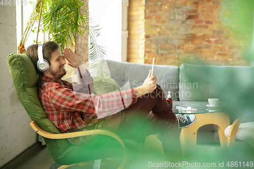 Image of Caucasian man staying at home during quarantine because of coronavirus spreading