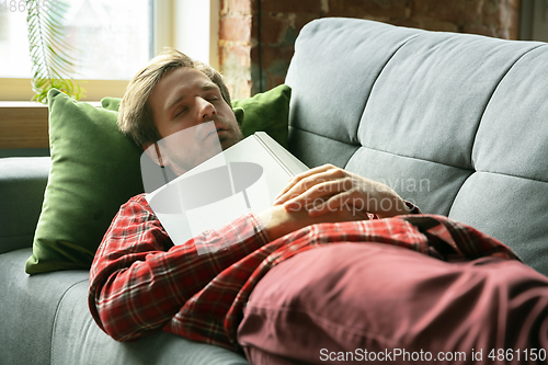 Image of Caucasian man staying at home during quarantine because of coronavirus spreading