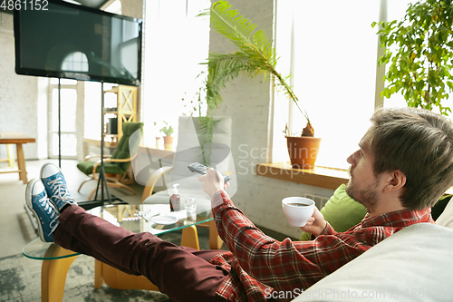 Image of Caucasian man staying at home during quarantine because of coronavirus spreading