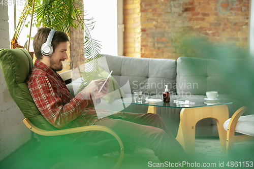 Image of Caucasian man staying at home during quarantine because of coronavirus spreading