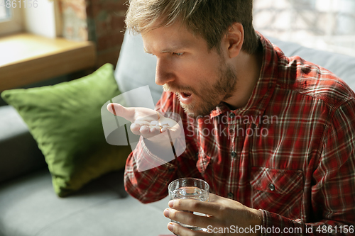 Image of Caucasian man staying at home during quarantine because of coronavirus spreading