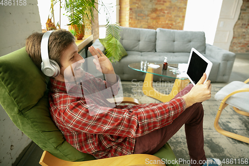 Image of Caucasian man staying at home during quarantine because of coronavirus spreading