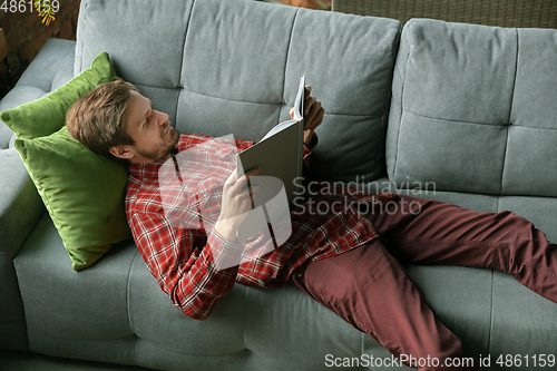 Image of Caucasian man staying at home during quarantine because of coronavirus spreading