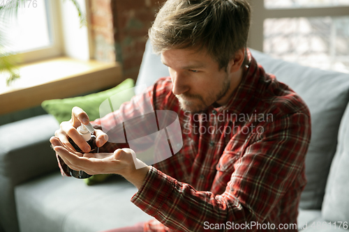 Image of Caucasian man staying at home during quarantine because of coronavirus spreading