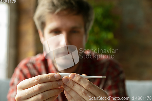 Image of Caucasian man staying at home during quarantine because of coronavirus spreading