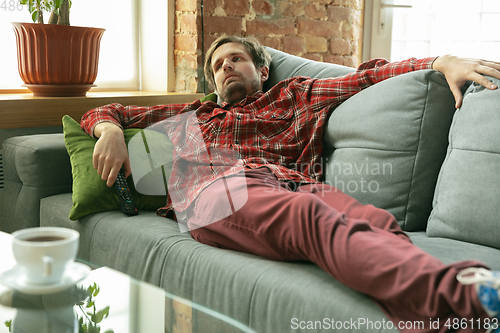 Image of Caucasian man staying at home during quarantine because of coronavirus spreading