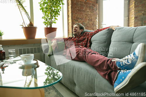 Image of Caucasian man staying at home during quarantine because of coronavirus spreading