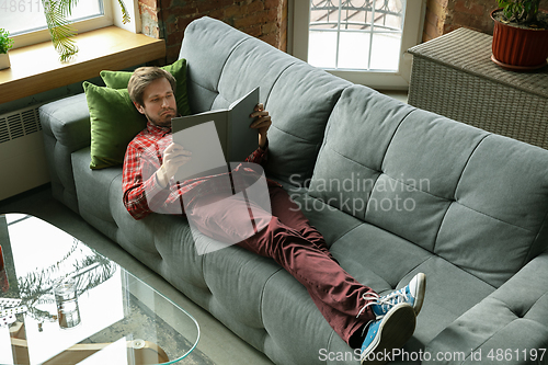 Image of Caucasian man staying at home during quarantine because of coronavirus spreading