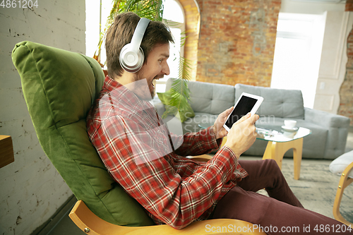 Image of Caucasian man staying at home during quarantine because of coronavirus spreading