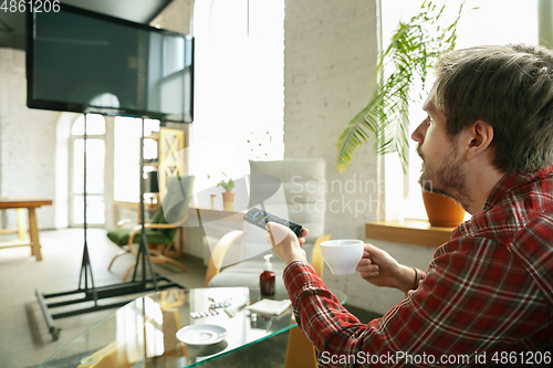 Image of Caucasian man staying at home during quarantine because of coronavirus spreading