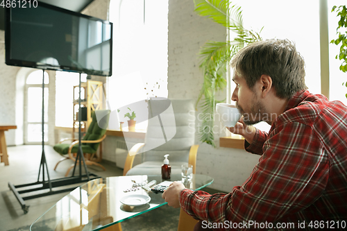 Image of Caucasian man staying at home during quarantine because of coronavirus spreading