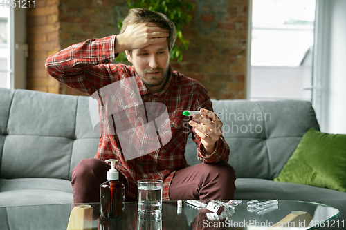 Image of Caucasian man staying at home during quarantine because of coronavirus spreading